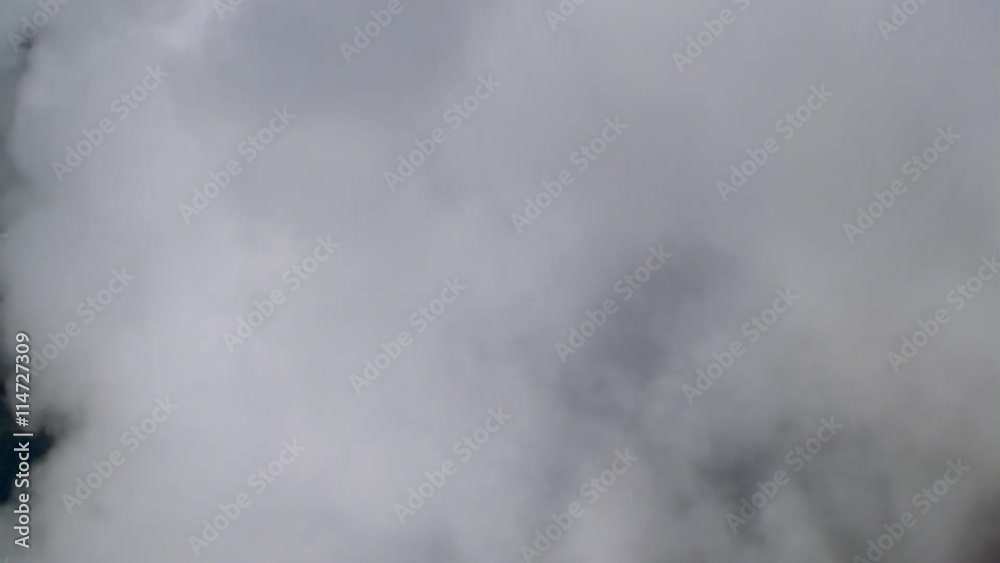 Flight through cloud to perpendicular view of ground, passenger POV Flight through cloud to perpendicular view of ground, passenger POV