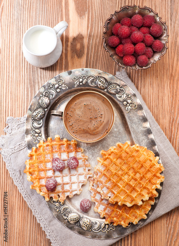 Belgian waffles with raspberry and espresso coffee on vintage plate