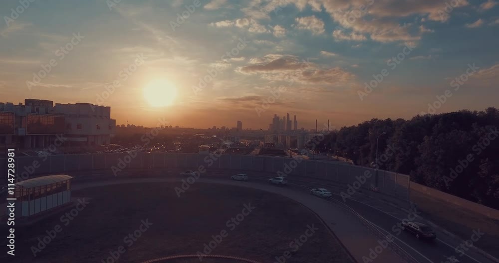 Aerial view of public park, tops of the trees, Moscow River, and city skyline during sunset in Moscow, Russia.  