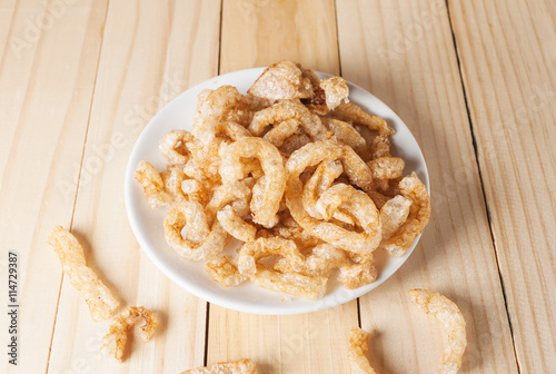 Pork rind junk food snack in white plate photo