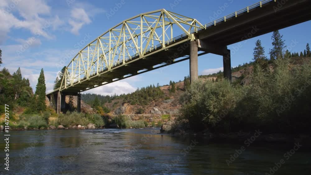 Drifting under Hellgate Bridge on the Rogue River, Oregon Drifting under Hellgate Bridge on the Rogue River, Oregon