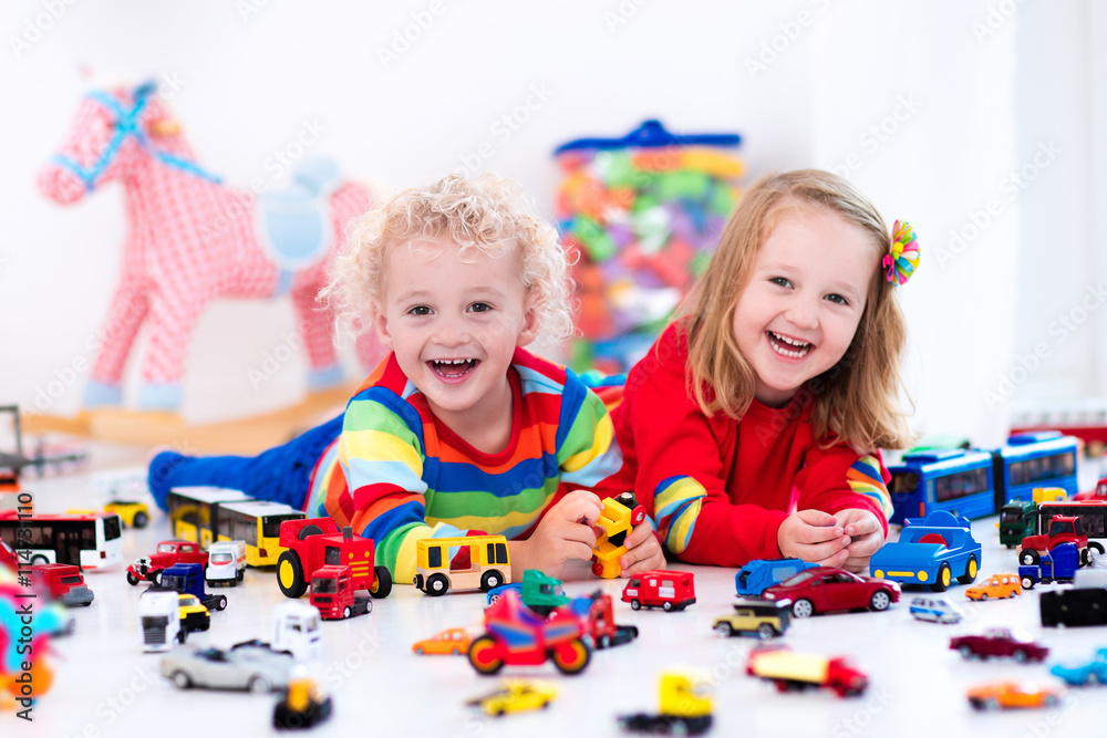 Fototapeta premium Little kids playing with toy cars