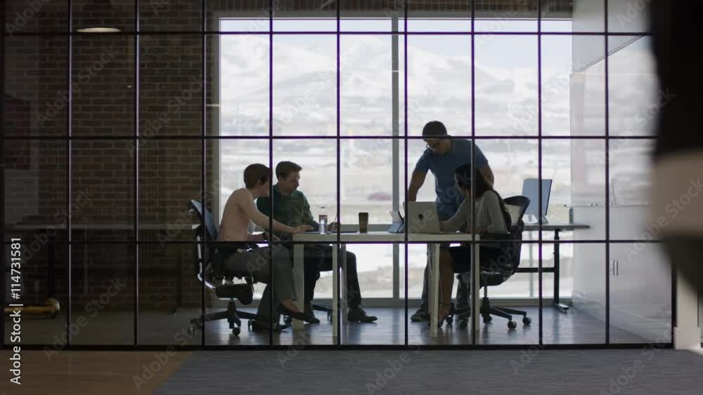Wide panning shot of business people talking in meeting / Lehi, Utah, United States