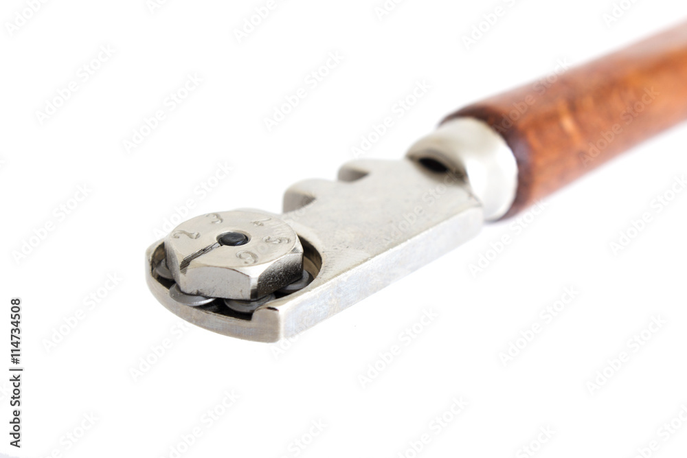 Glass cutter, tool for cutting glass with iron wheels isolated Glass cutter, tool for cutting glass with iron wheels isolated