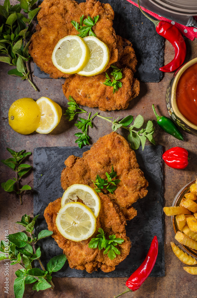 Schnitzel with fries, salad and herbs Schnitzel with fries, salad and herbs
