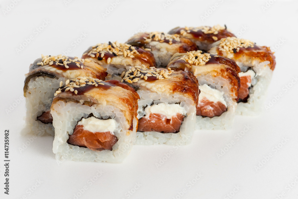 Sushi rolls with sauce, sesame, fish and cheese on white background Sushi rolls with sauce, sesame, fish and cheese on white background