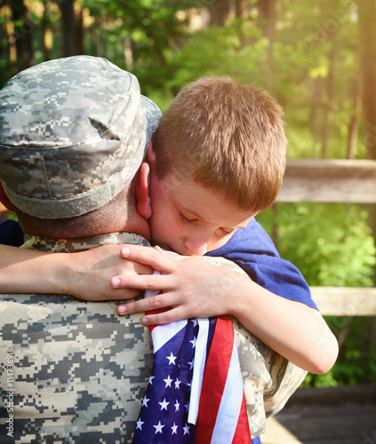 Photos Soldier Father and Son Hugging with American Flag