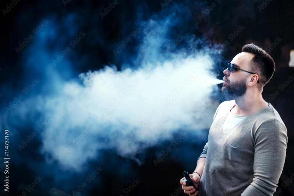 Vaper with beard in sunglasses vaping outdoor Vaper with beard in sunglasses vaping outdoor