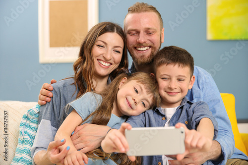 Happy family taking selfie ...