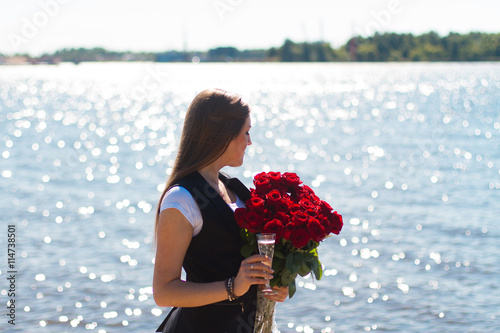 Image of sexy woman posin on sea with glass and roses