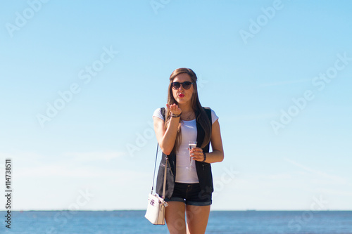 Image of sexy woman posin on sea with glass