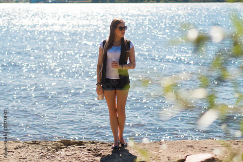 Image of sexy woman posin on sea with glass