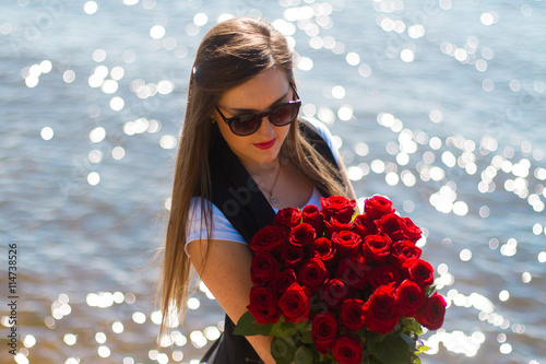Image of sexy woman posin on sea with roses