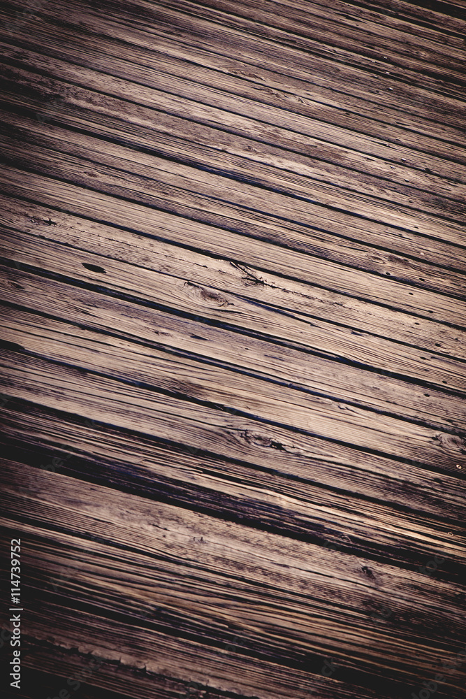 Fototapeta premium Weathered boardwalk planks of wood with heavy grain and vintage tone