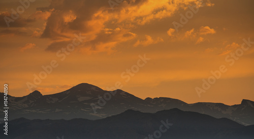 silhouette of mountains against sunset sky
