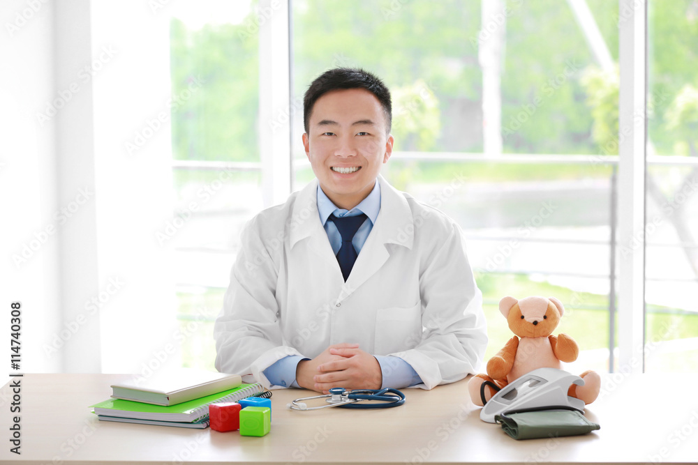 Handsome pediatrician doctor in office Handsome pediatrician doctor in office