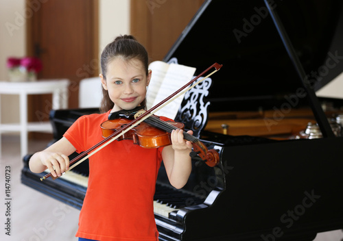 Little girl playing violin ...