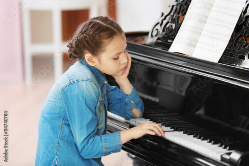 Tired girl playing piano