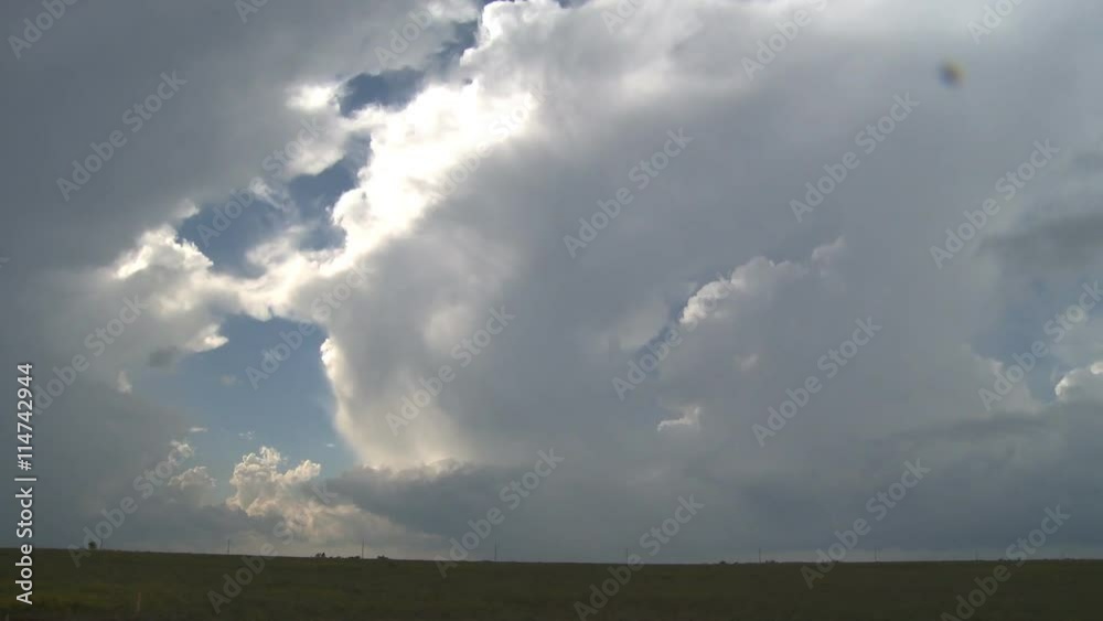 Time-lapse stormclouds rushing over a prairie landscape Time-lapse stormclouds rushing over a prairie landscape