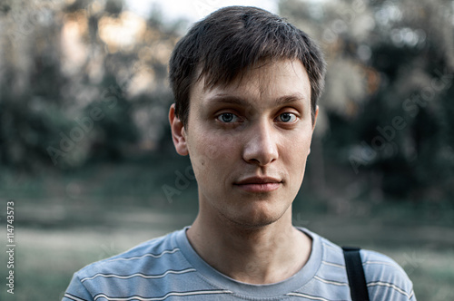 portrait of a young blue eyed men in the Park