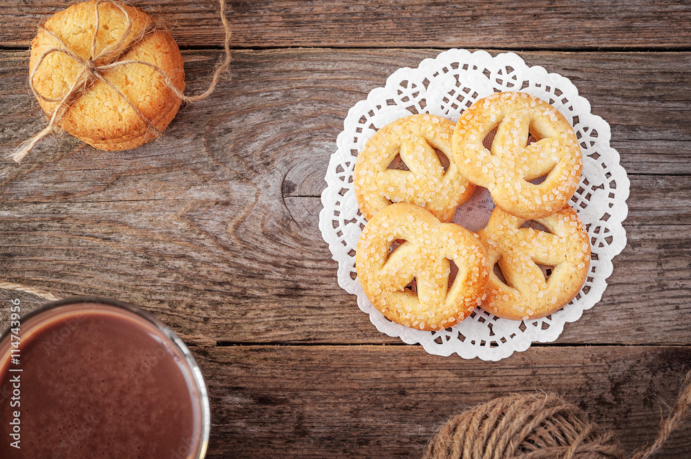 Butter cookies closeup on Rustic Wooden Background with a cup Butter cookies closeup on Rustic Wooden Background with a cup