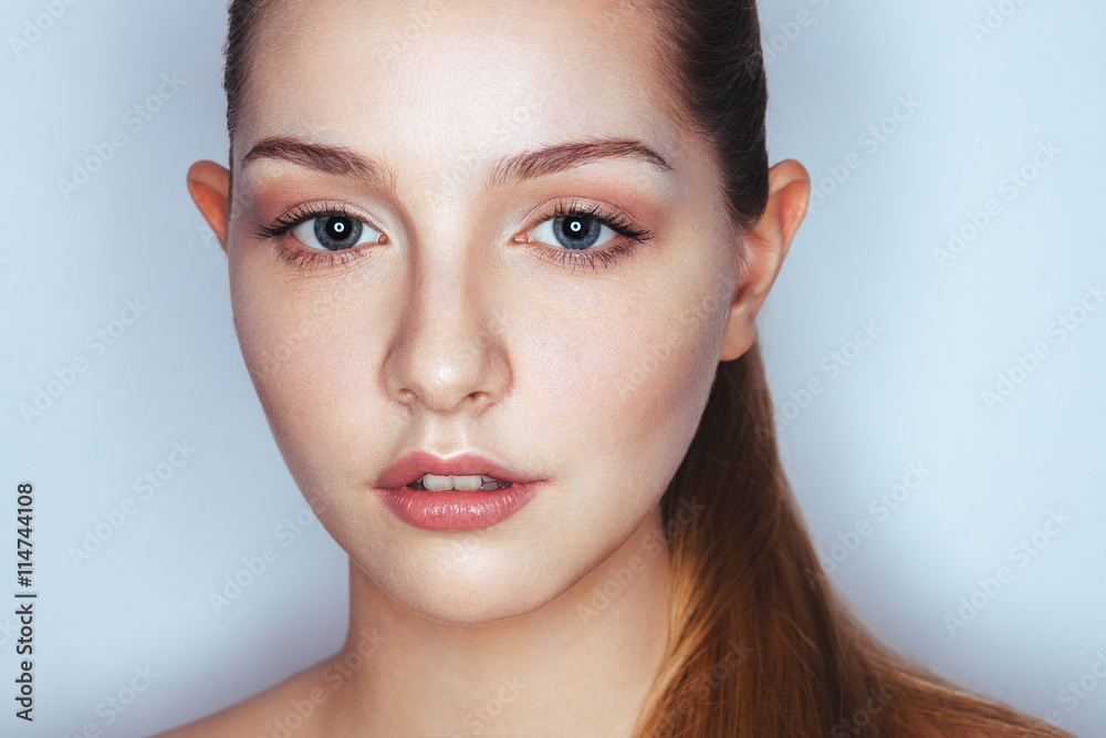 Glamour close up portrait of young beautiful woman model with trendy makeup. Fashion shiny highlighter on skin, sexy gloss lips make-up and dark eyebrows. Glamour close up portrait of young beautiful woman model with trendy makeup. Fashion shiny highlighter on skin, sexy gloss lips make-up and dark eyebrows.