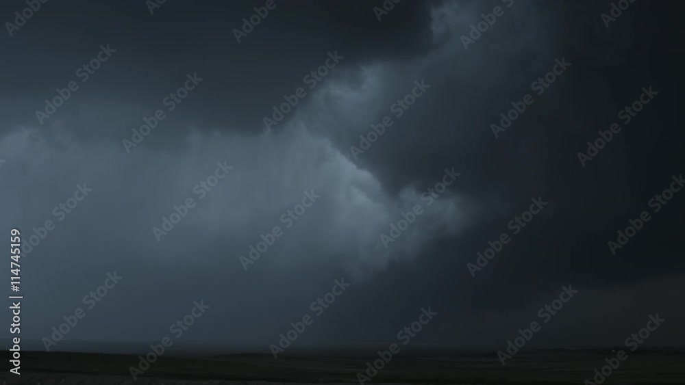 Heavy dark wall cloud dropping a curtain of rain over prairie, time lapse Heavy dark wall cloud dropping a curtain of rain over prairie, time lapse