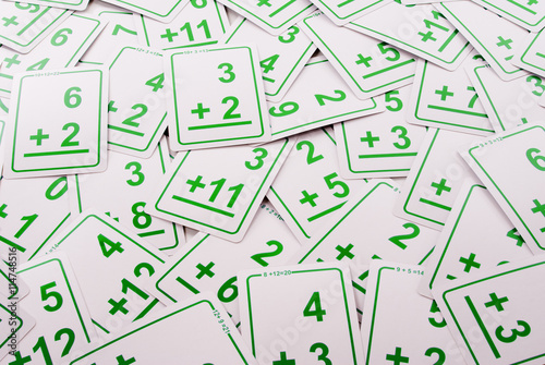 Education: Green addition math cards  randomly spread out on table. Educational school supplies.
Edicational background