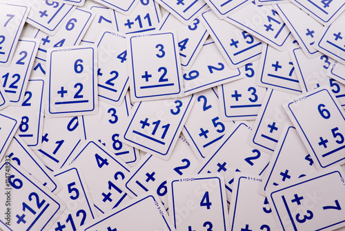 Education: Addition math cards (blue) randomly spread out on table. Educational school supplies.
Edicational background