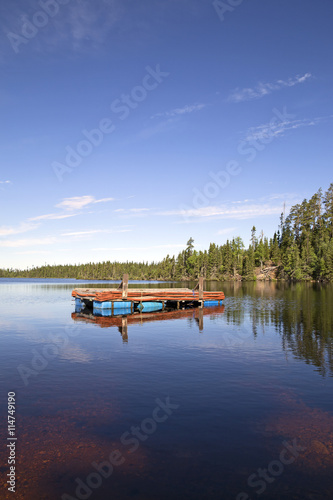 Old floating pier on a calm lake