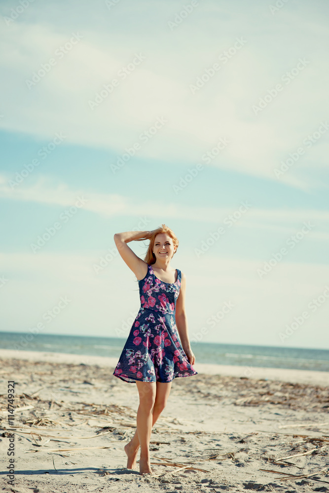 Young woman on the sea beach