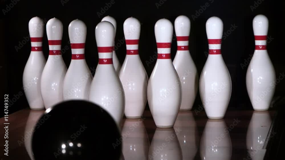 Ultra-slow motion shot of bowling ball knocking down all ten pins