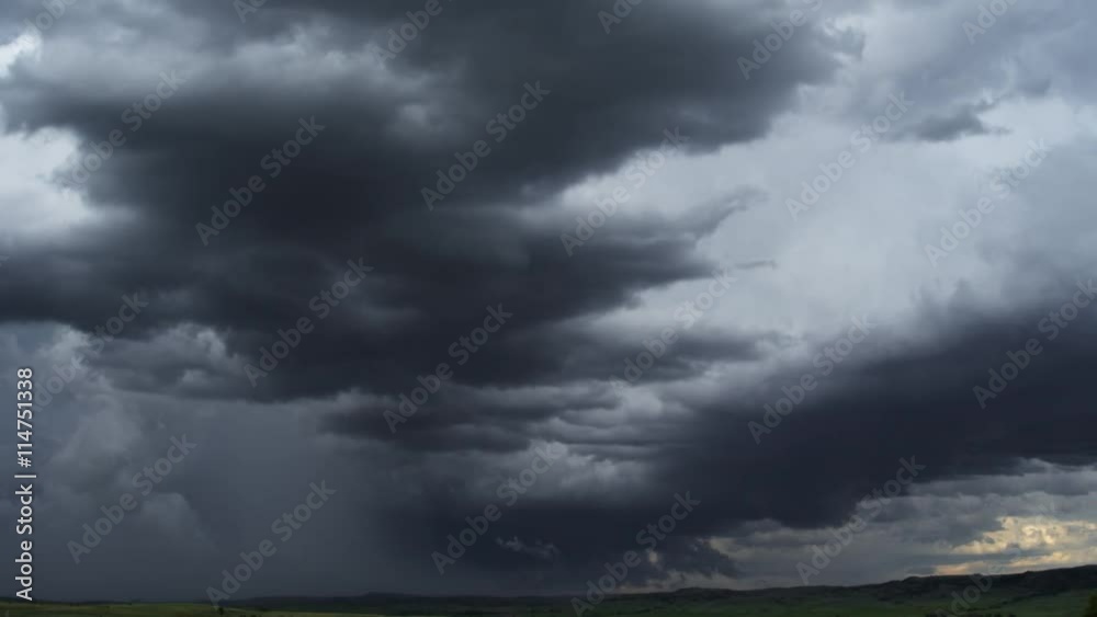 Low gray clouds darkening above the prairie, time lapse Low gray clouds darkening above the prairie, time lapse