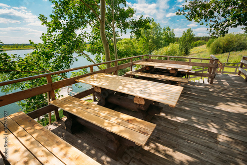 Wooden Tables And Benches In Outdoor Cafe In Nature. Sunny Summer