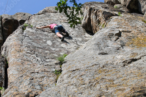 Girl climbing on the rock