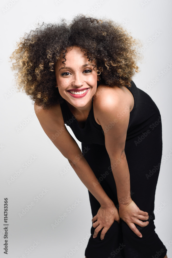 Young black woman with afro hairstyle smiling Young black woman with afro hairstyle smiling