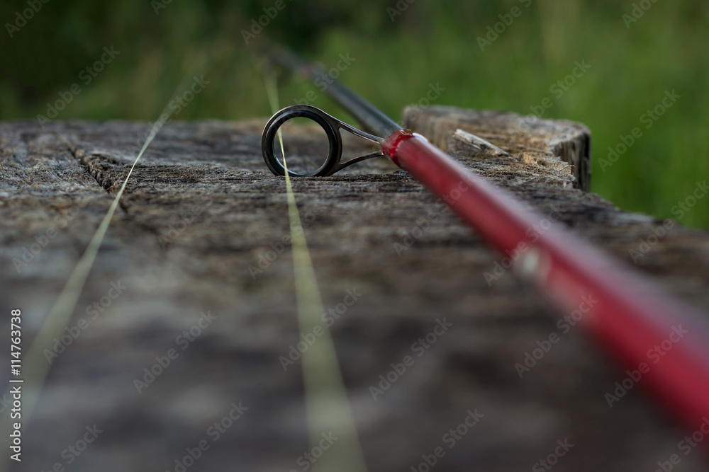 Obraz premium Fishing rod on wood