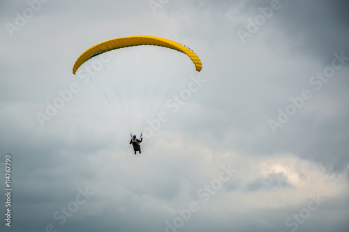 Hang glider maneuvering through the storm clouds at Dunstable Downs in UK summer