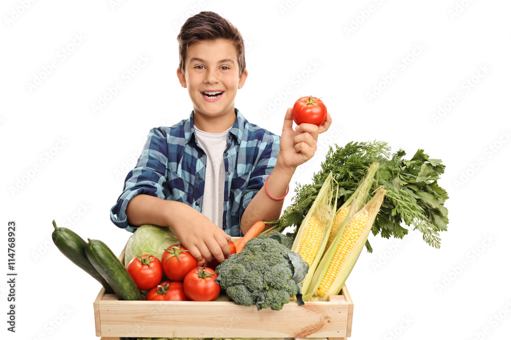 Boy behind a crate with vegetables Boy behind a crate with vegetables