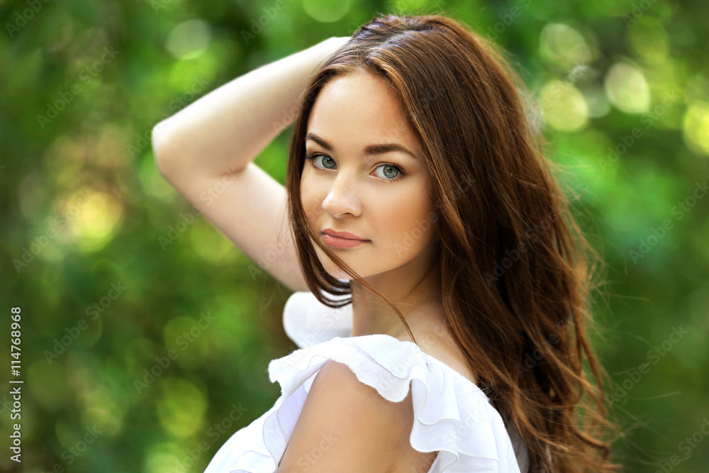 Beautiful girl relaxing in green park