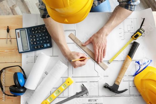 Man working with engineer b...