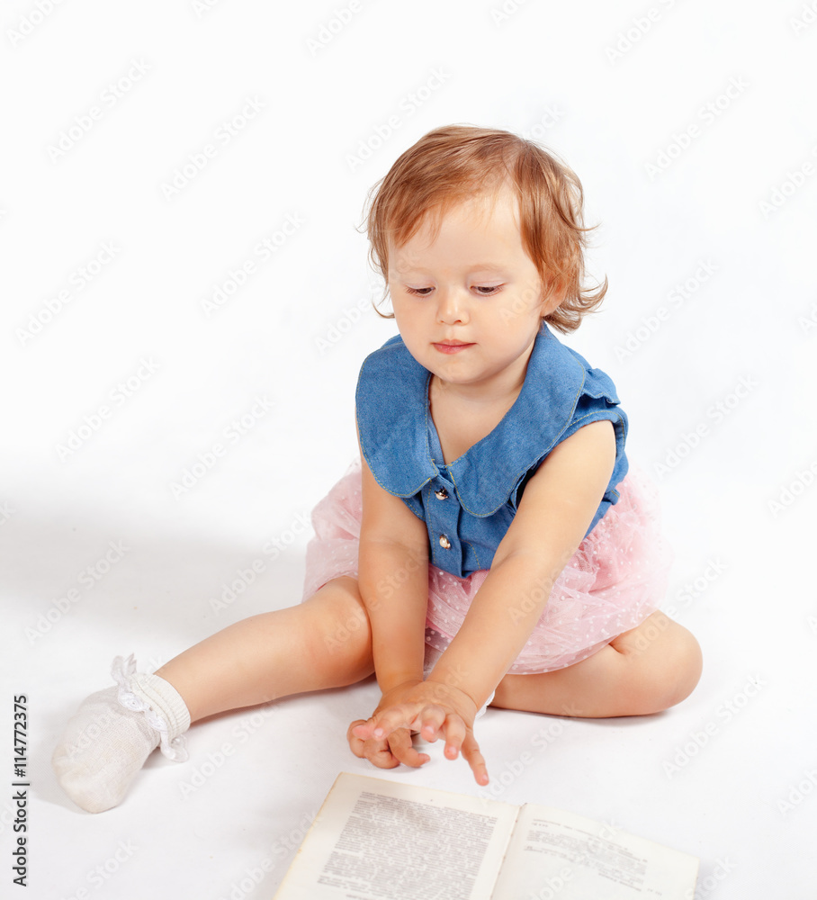 a little girl stands on the books a little girl stands on the books