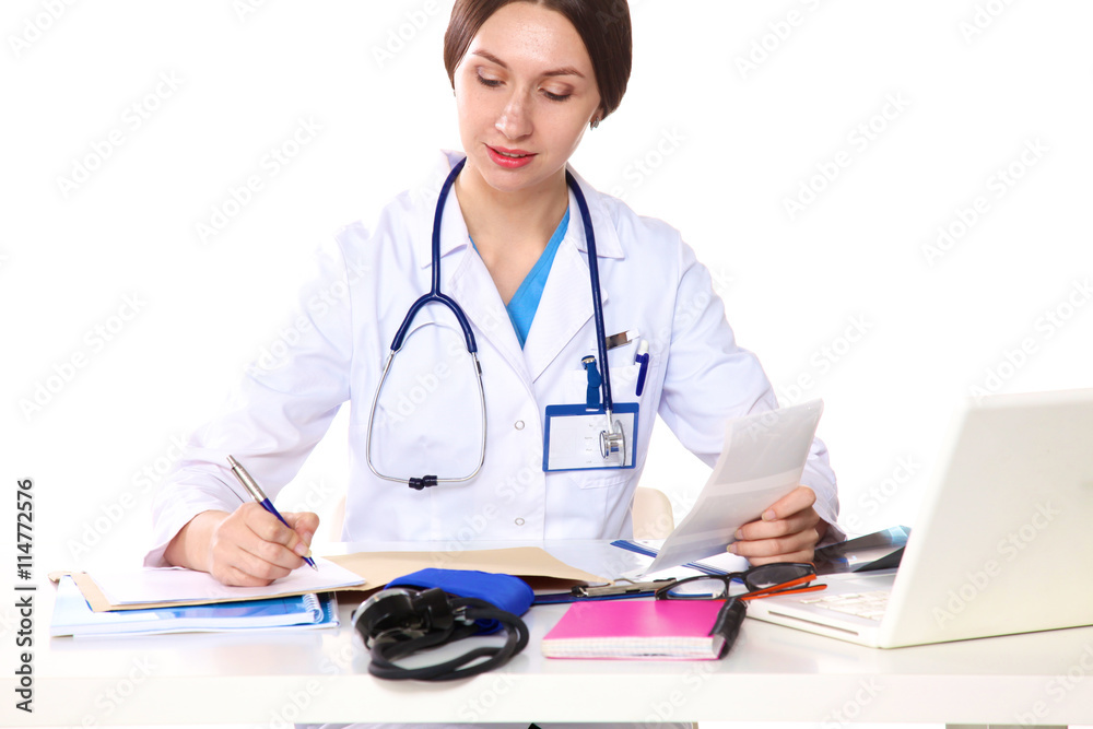 young girl doctor sits at a desk in the Office young girl doctor sits at a desk in the Office