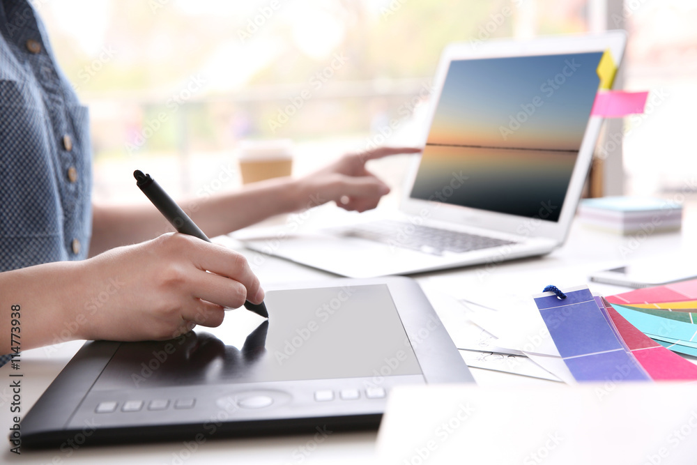 Fototapeta premium Woman using graphic tablet at office