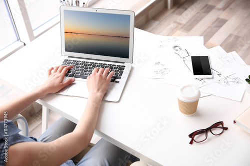 Woman working at computer a...