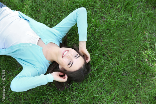 Beautiful girl lying on gre...