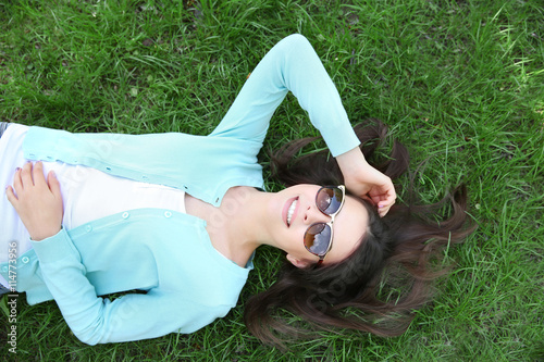 Beautiful girl lying on gre...