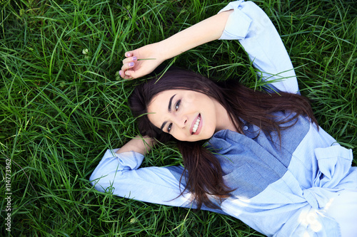 Beautiful girl lying on gre...