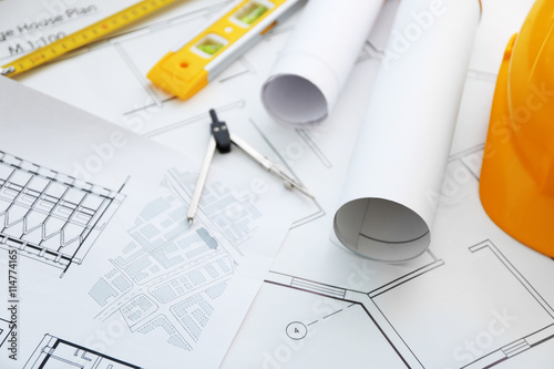 Construction drawings with helmet and other tools closeup