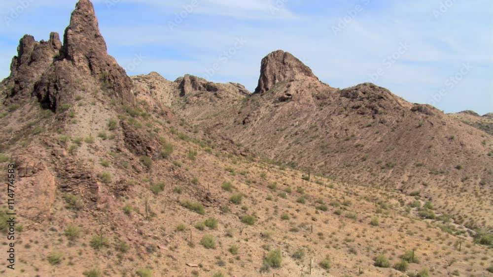 Flight across a narrow valley between rugged desert hills Flight across a narrow valley between rugged desert hills